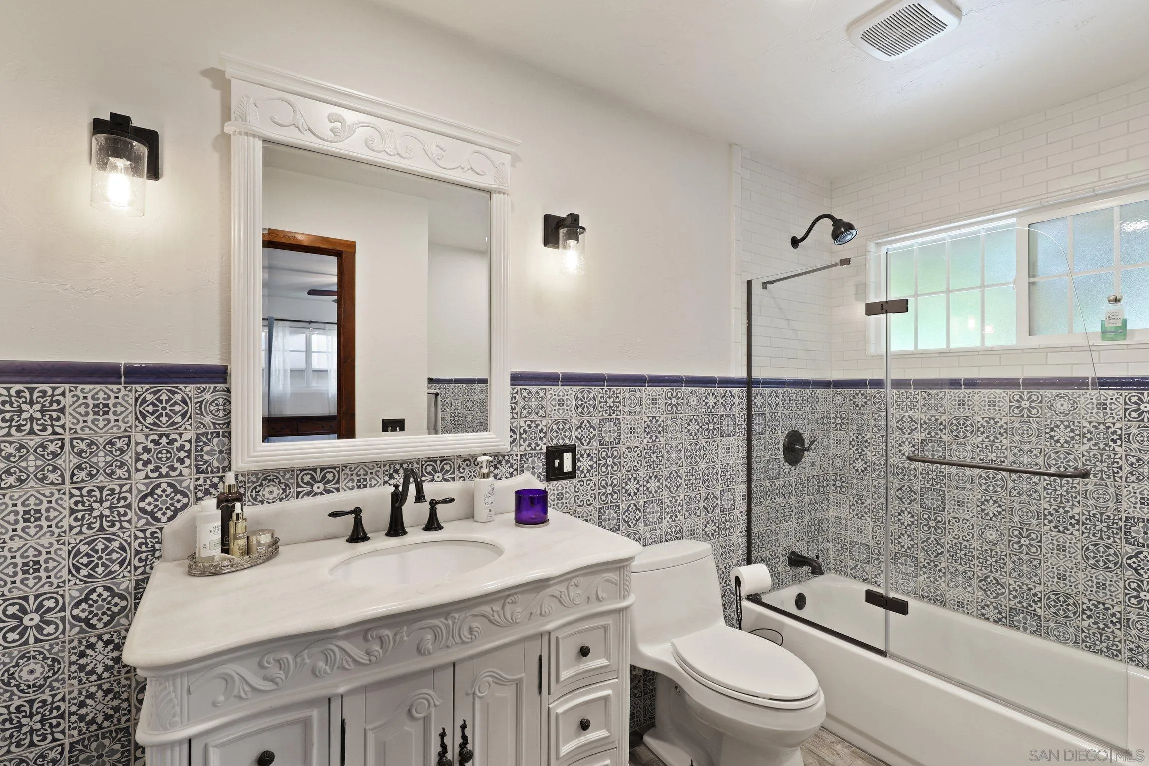 13107 Sudan Road Poway, CA 92064 - Photo 59 of 59 a bathroom with a granite countertop sink a toilet a mirror and shower