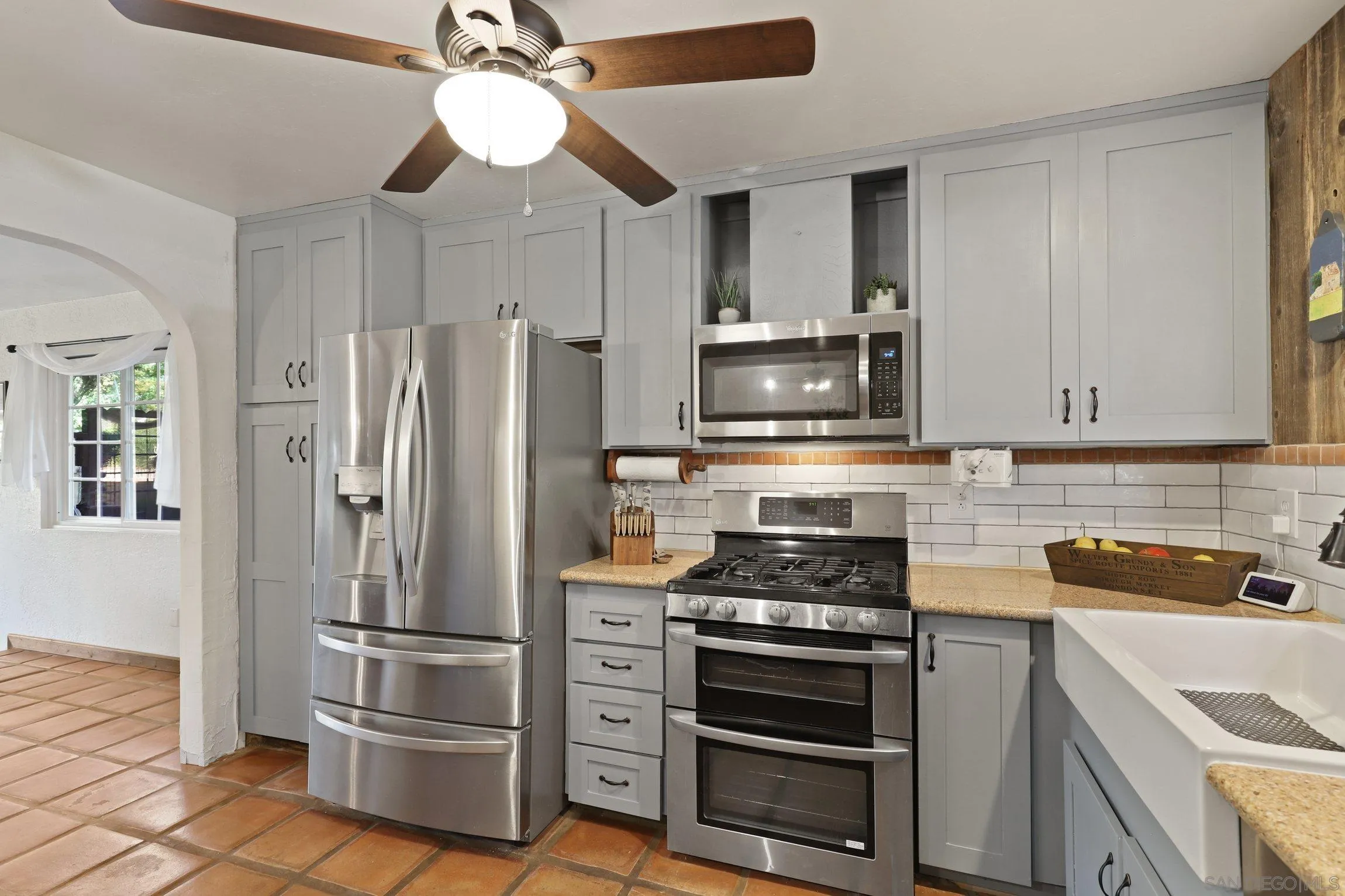 13107 Sudan Road Poway, CA 92064 - Photo 10 of 59 a kitchen with refrigerator a microwave and cabinets