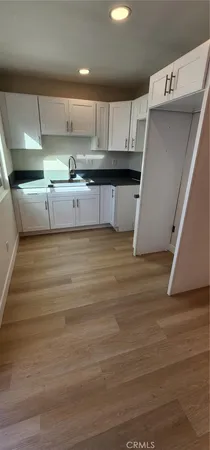 a kitchen with stainless steel appliances granite countertop a sink a stove and a refrigerator