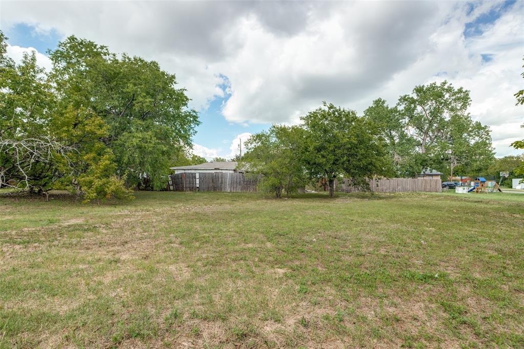 906 Hamilton Street McKinney, TX 75069 - Photo 4 of 13 a front view of a house with a yard