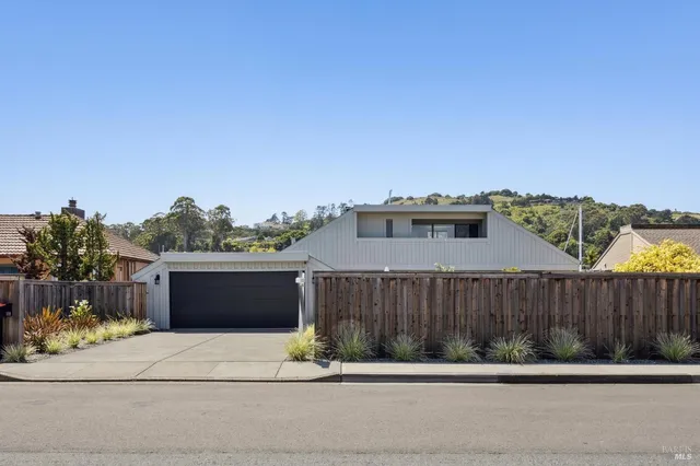 a terrace with a bench and wooden fence