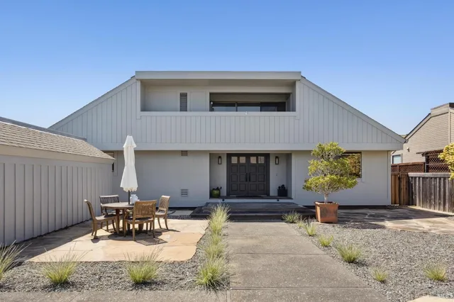 a view of a hallway with wooden floor and a couch
