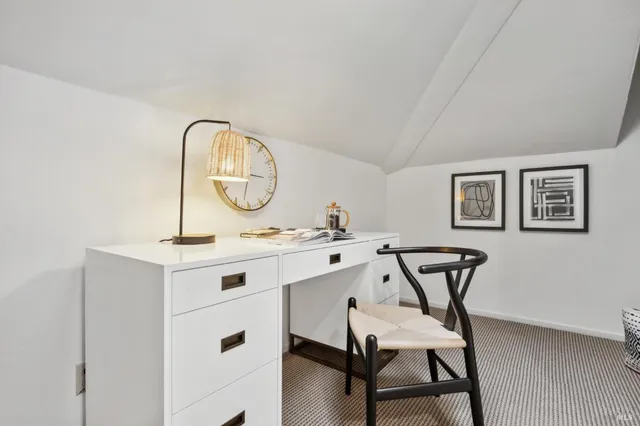 a view of a hallway with rack on the wall