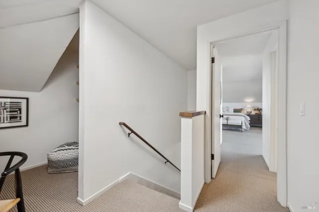 a spacious bedroom with a bed and a dresser