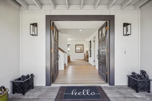 a living room with furniture a fireplace and a floor to ceiling window