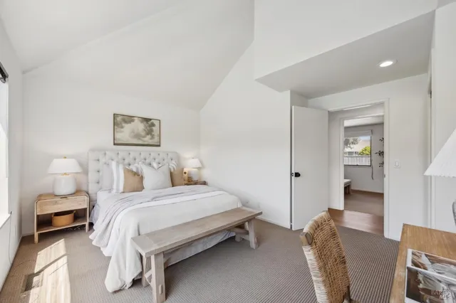 a bedroom with two beds and painting on the wall