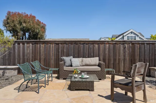 a view of a house with backyard and sitting area