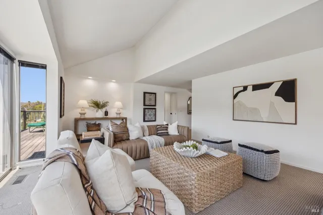 a living room with furniture a fireplace and a window