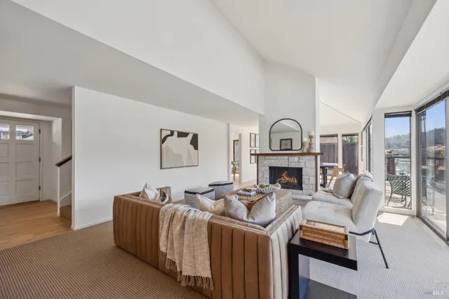 a living room with furniture a window and a fireplace