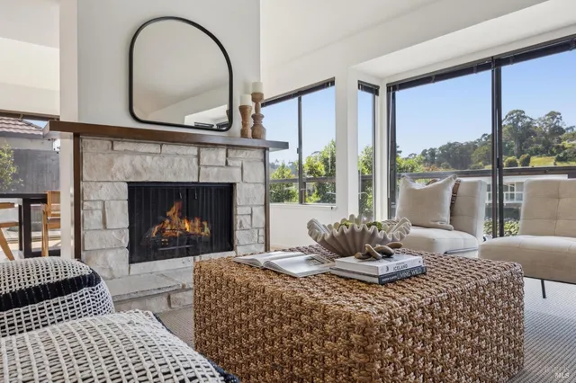 a view of a dining room with furniture large windows and wooden floor