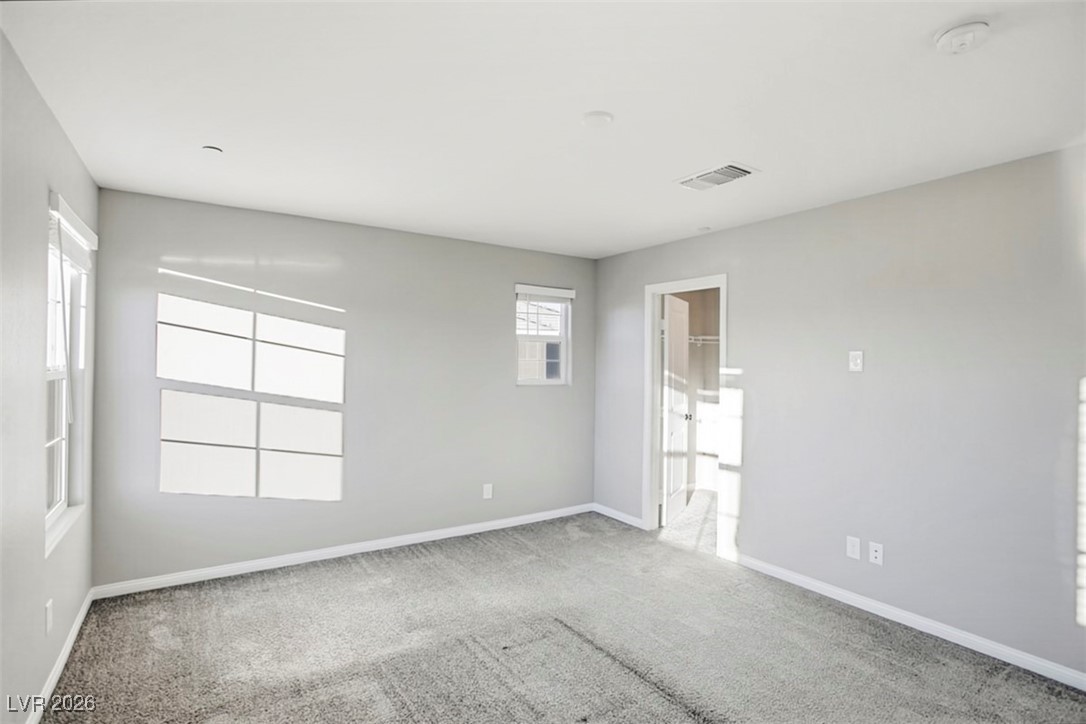 2865 Mincio Street Henderson, NV 89044 - Photo 12 of 33 Carpeted spare room featuring baseboards