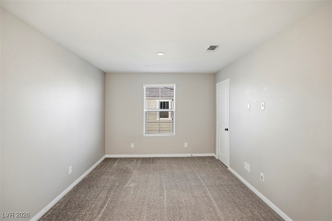 2865 Mincio Street Henderson, NV 89044 - Photo 16 of 33 Empty room with light colored carpet and baseboards