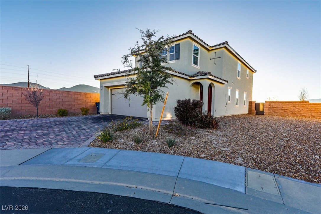 2865 Mincio Street Henderson, NV 89044 - Photo 2 of 33 View of front of home featuring stucco siding, decorative driveway, a garage, and a tile roof