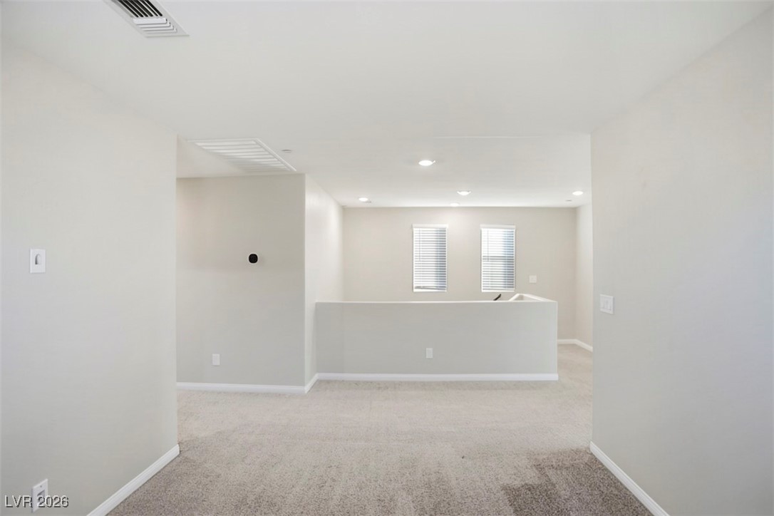 2865 Mincio Street Henderson, NV 89044 - Photo 17 of 33 Empty room with light carpet and recessed lighting