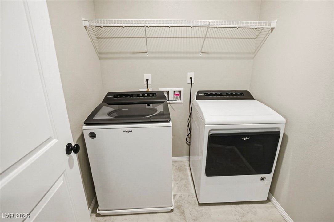 2865 Mincio Street Henderson, NV 89044 - Photo 18 of 33 Laundry area featuring baseboards and washer and clothes dryer