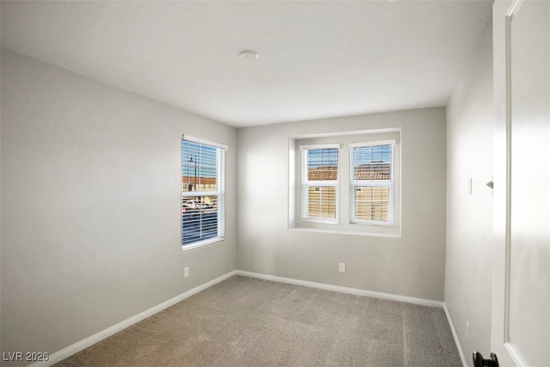 2865 Mincio Street Henderson, NV 89044 - Photo 20 of 33 Unfurnished room with light colored carpet and baseboards