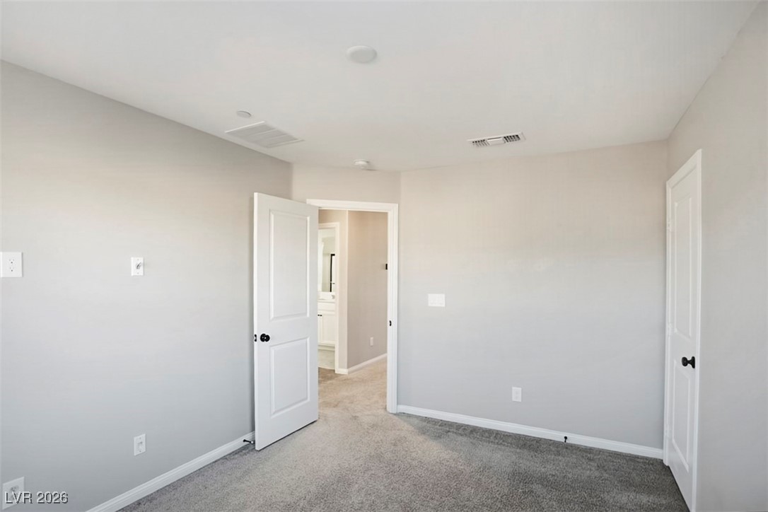 2865 Mincio Street Henderson, NV 89044 - Photo 21 of 33 Empty room with light carpet and baseboards