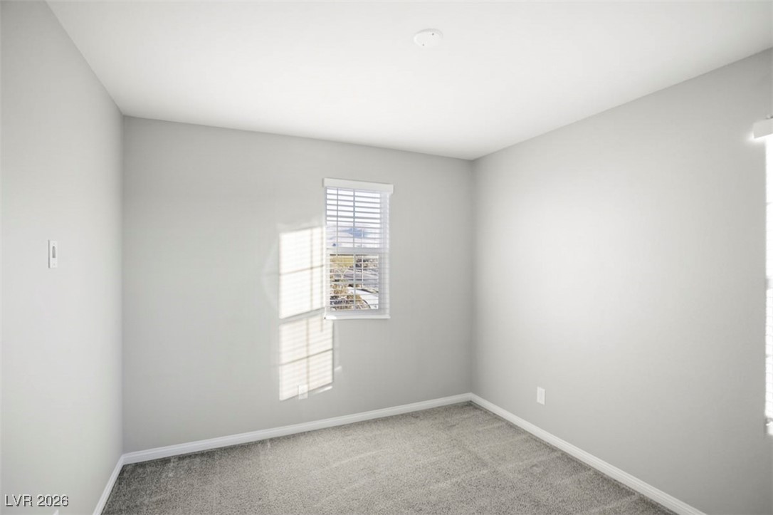 2865 Mincio Street Henderson, NV 89044 - Photo 22 of 33 Empty room featuring light carpet and baseboards