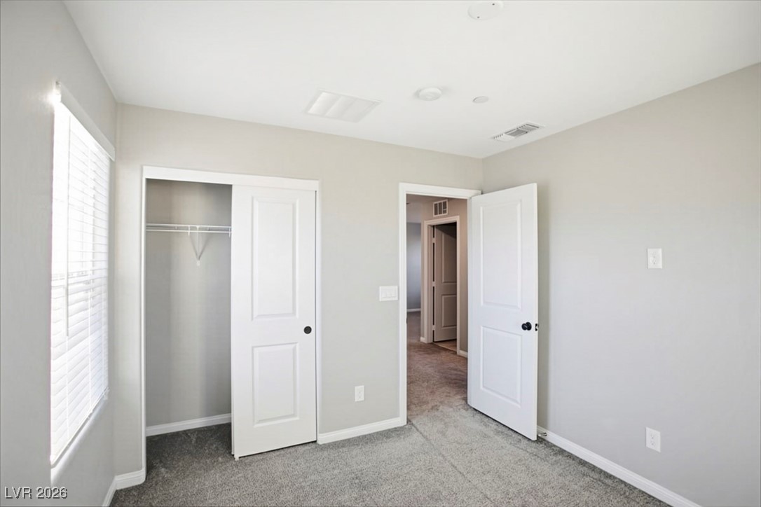 2865 Mincio Street Henderson, NV 89044 - Photo 23 of 33 Unfurnished bedroom with light colored carpet and a closet