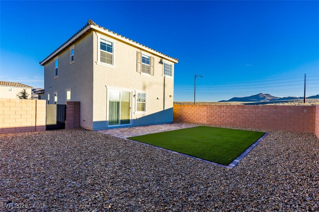 2865 Mincio Street Henderson, NV 89044 - Photo 24 of 33 Back of house with a patio, a fenced backyard, stucco siding, and a mountain view