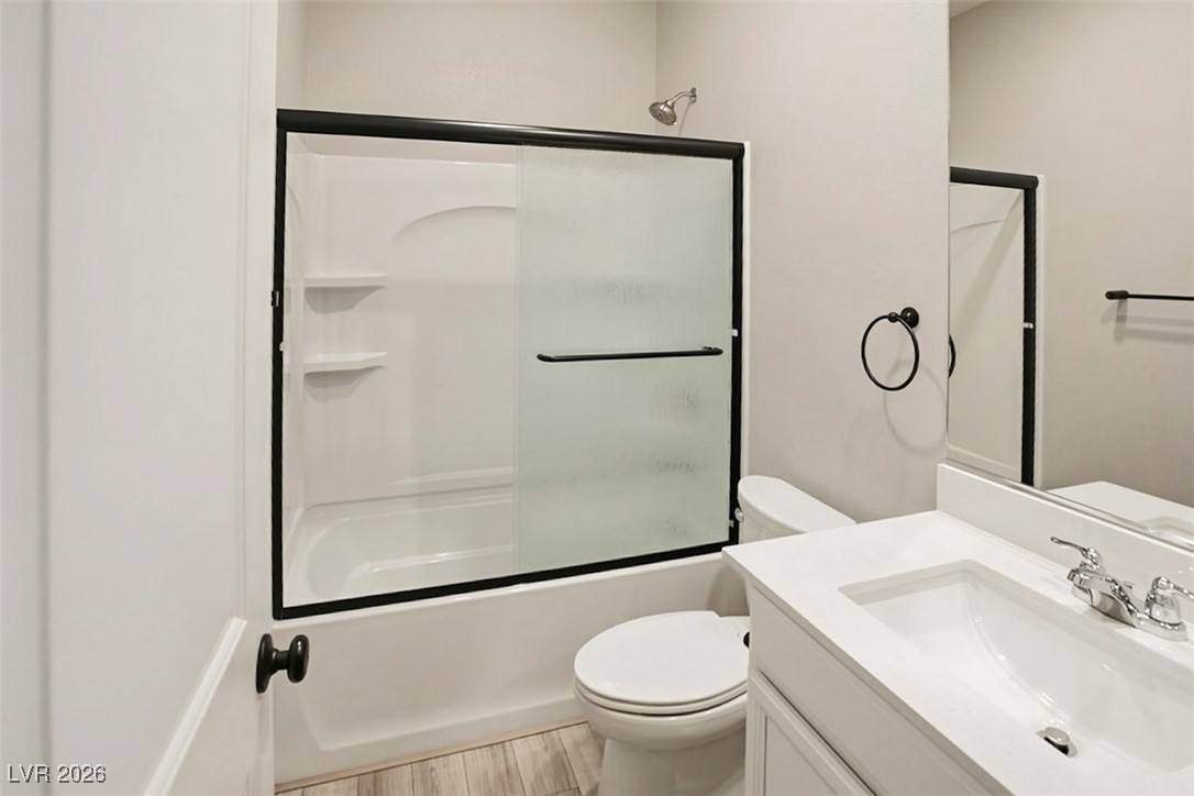 2865 Mincio Street Henderson, NV 89044 - Photo 5 of 33 Full bathroom with vanity, bath / shower combo with glass door, and light wood-style flooring