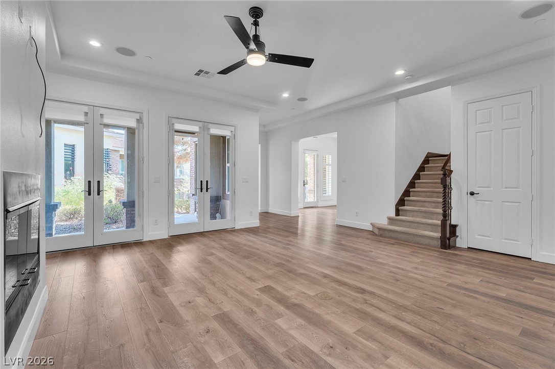 11280 Granite Ridge Drive, Unit 1037 Las Vegas, NV 89135 - Photo 14 of 51 Unfurnished living room with a ceiling fan, french doors, light wood-type flooring, and recessed lighting