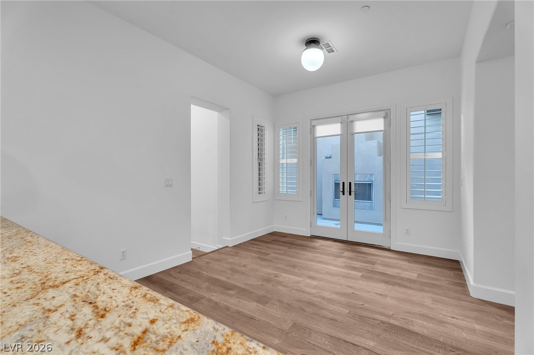 11280 Granite Ridge Drive, Unit 1037 Las Vegas, NV 89135 - Photo 22 of 51 Featuring French doors and light wood-style flooring over looks outdoor fireplace