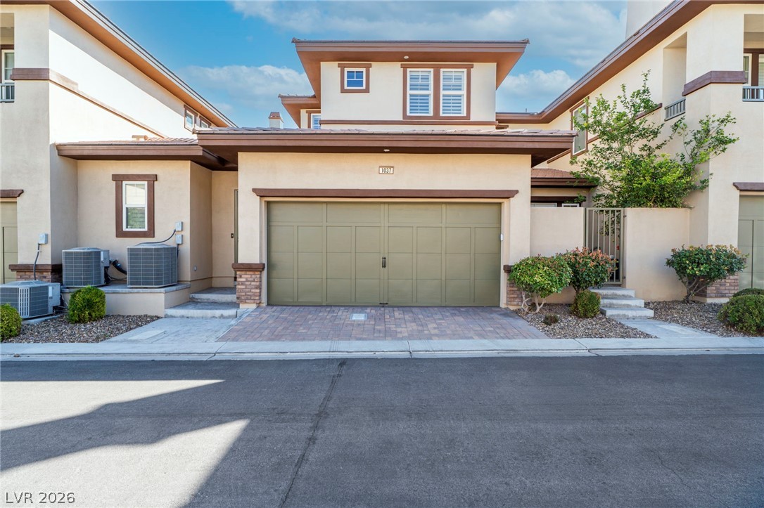 11280 Granite Ridge Drive, Unit 1037 Las Vegas, NV 89135 - Photo 3 of 51 View of rear of property. Stucco siding, driveway, and a garage