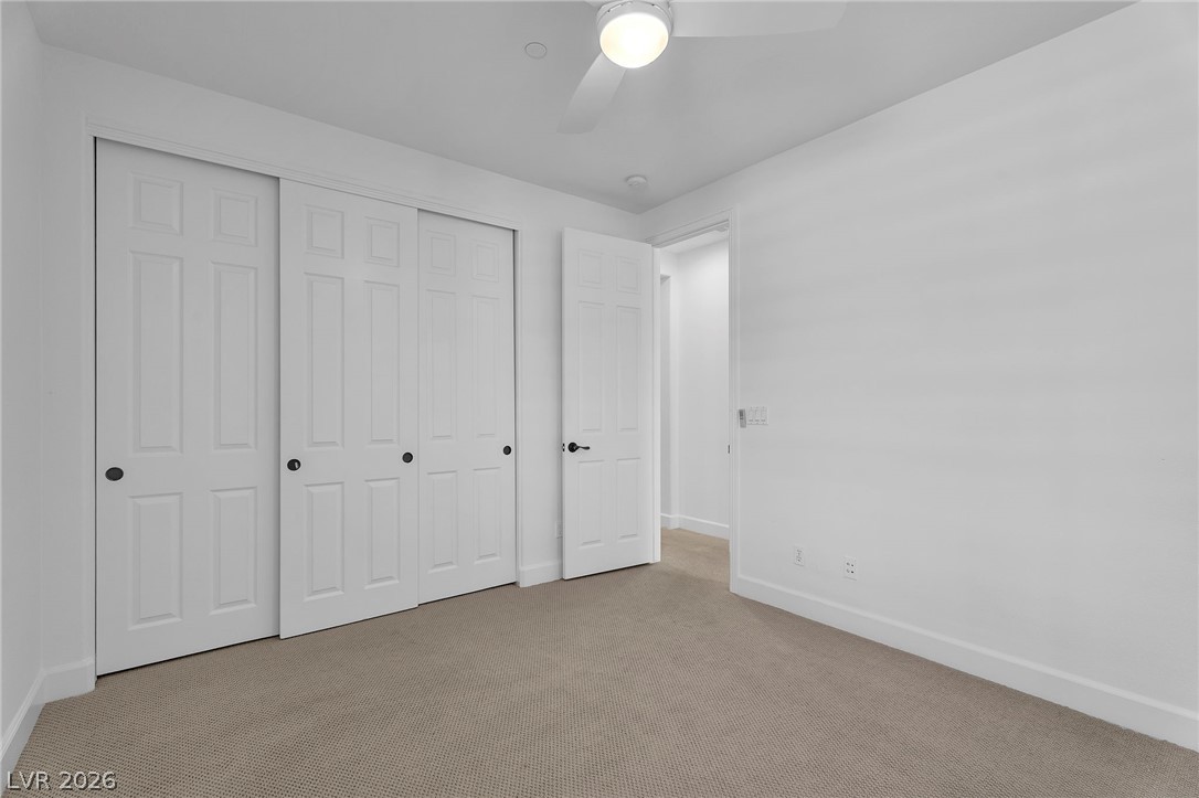 11280 Granite Ridge Drive, Unit 1037 Las Vegas, NV 89135 - Photo 34 of 51 Unfurnished bedroom with carpet, a closet, and a ceiling fan