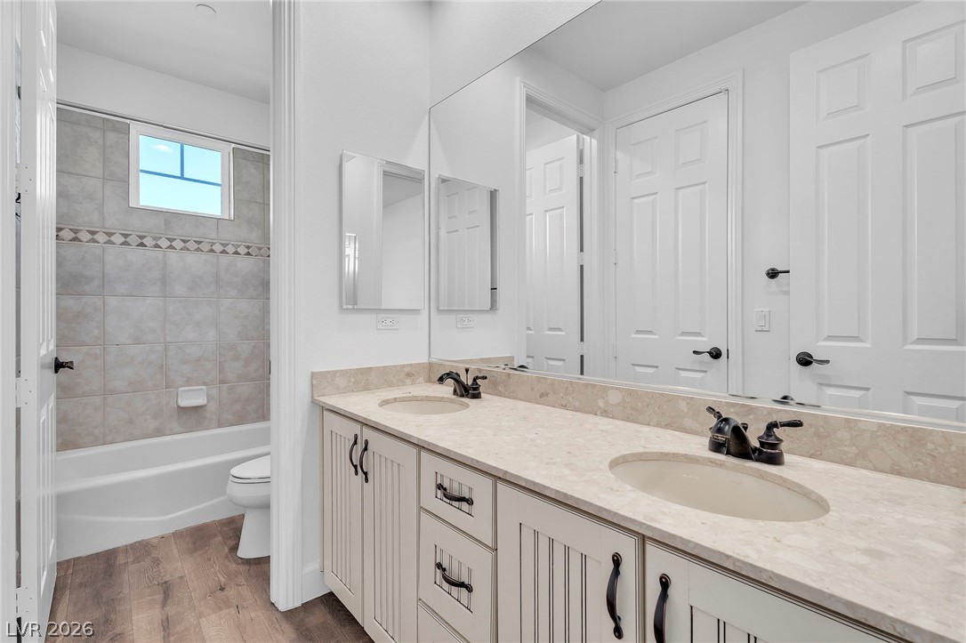 11280 Granite Ridge Drive, Unit 1037 Las Vegas, NV 89135 - Photo 35 of 51 Bathroom featuring double vanity (jack and jill), light wood finished floors, and shower / washtub combination