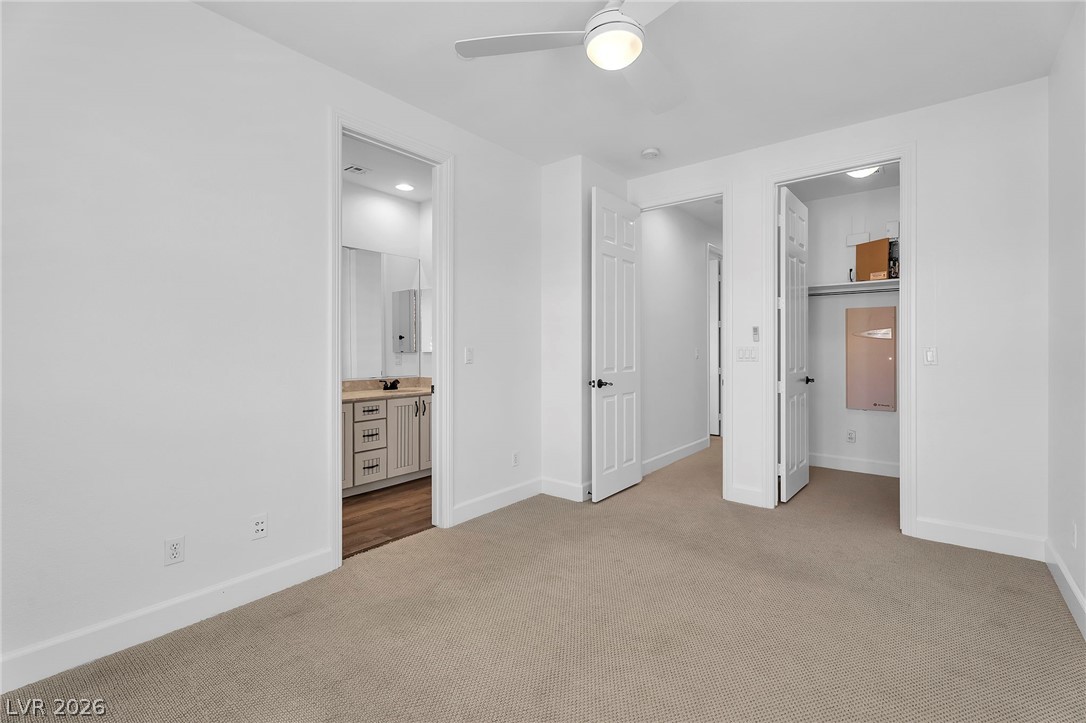 11280 Granite Ridge Drive, Unit 1037 Las Vegas, NV 89135 - Photo 37 of 51 Unfurnished bedroom with connected bathroom, light colored carpet, ceiling fan, and recessed lighting