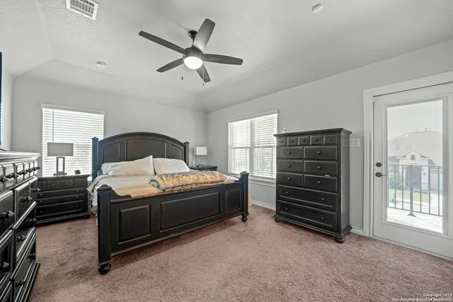 a bedroom with a bed and a ceiling fan
