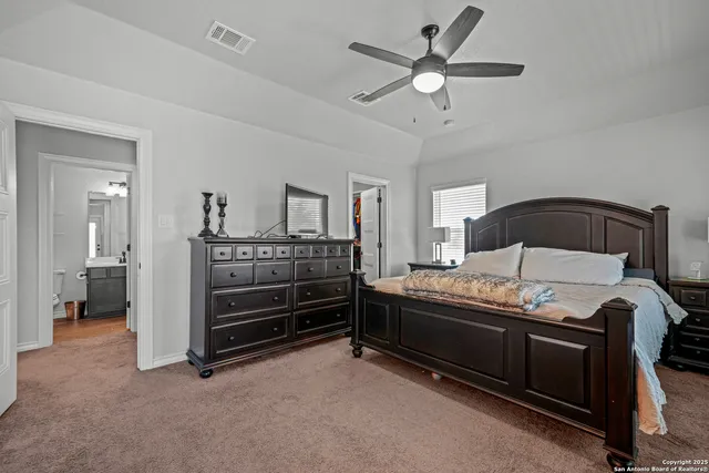 a bedroom with a bed and a ceiling fan