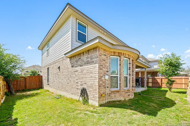 a front view of house with a garden and patio