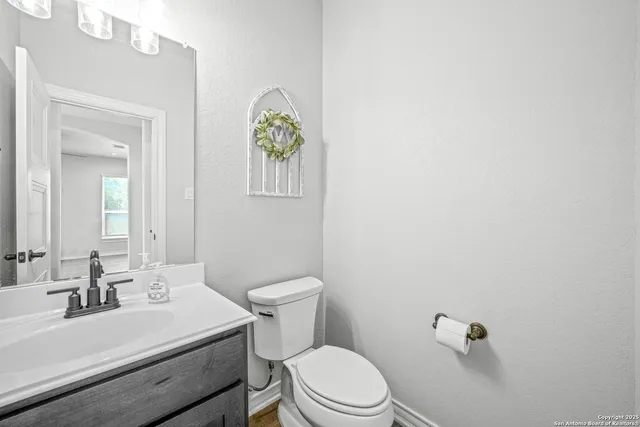 a white toilet sitting next to a bathroom sink