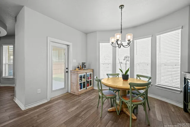 a dining room with furniture window and wooden floor