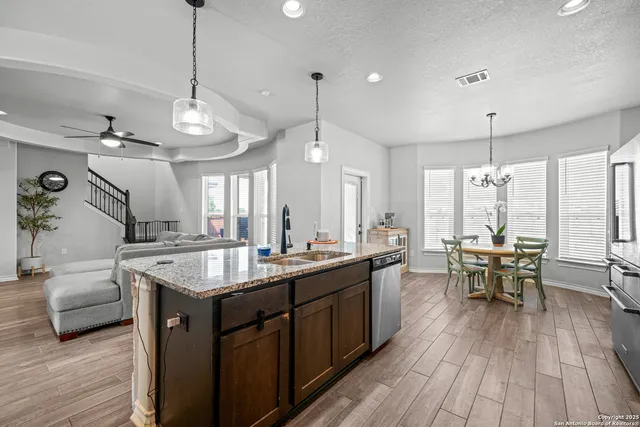 a kitchen with sink stove and wooden floor
