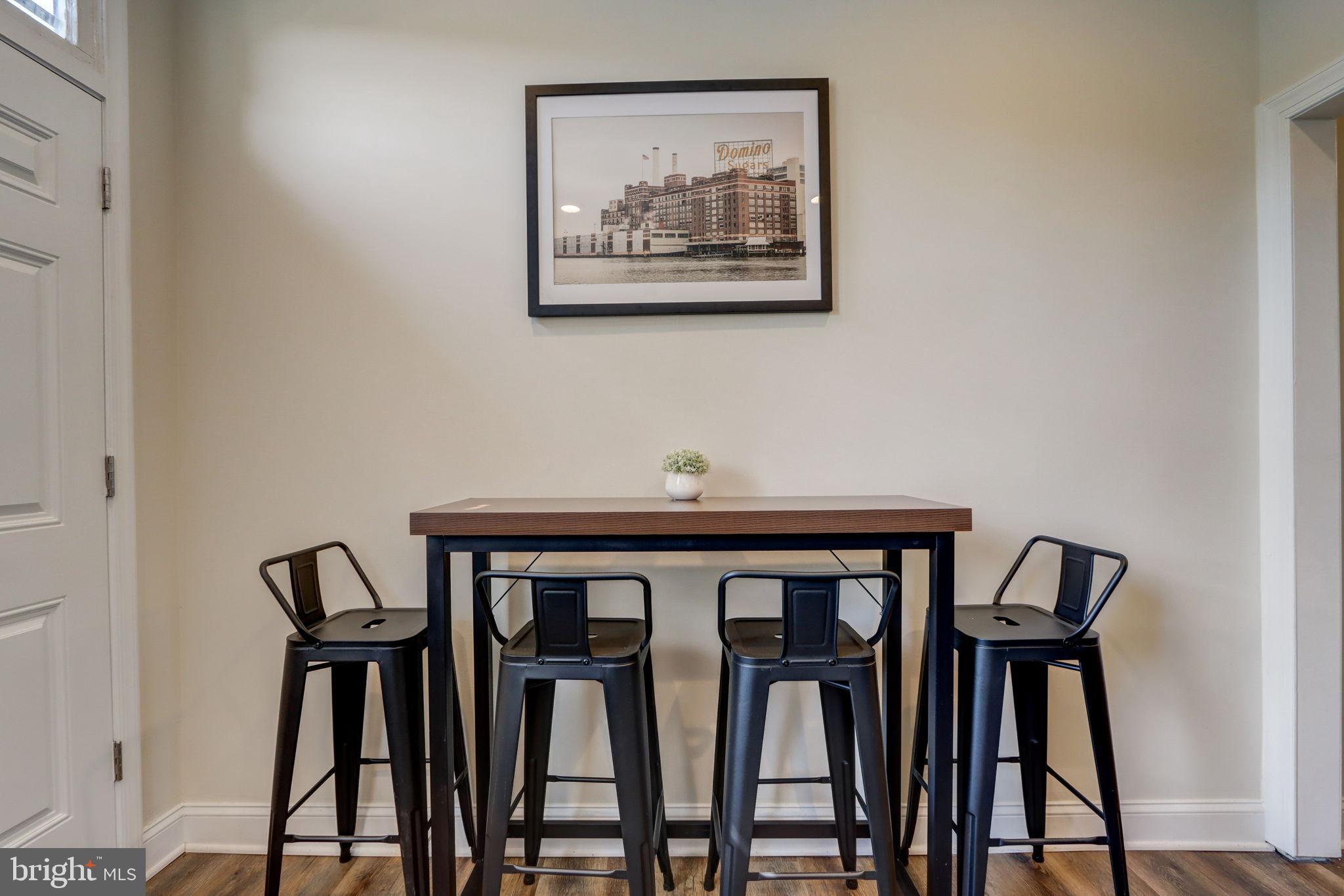1628 North Calvert Street Baltimore, MD 21202 - Photo 13 of 50 a view of a dining area with furniture and wooden floor
