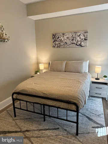 a large bed sitting in a bedroom and lamp