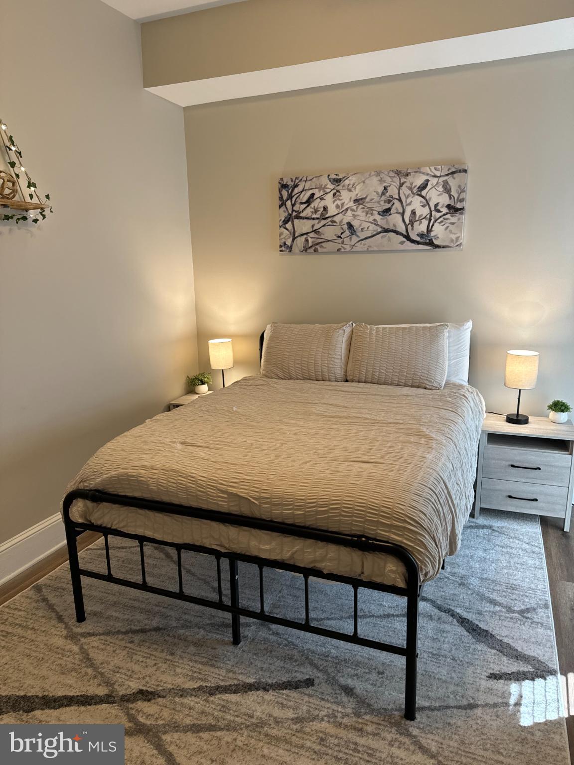 1628 North Calvert Street Baltimore, MD 21202 - Photo 26 of 50 a large bed sitting in a bedroom and lamp