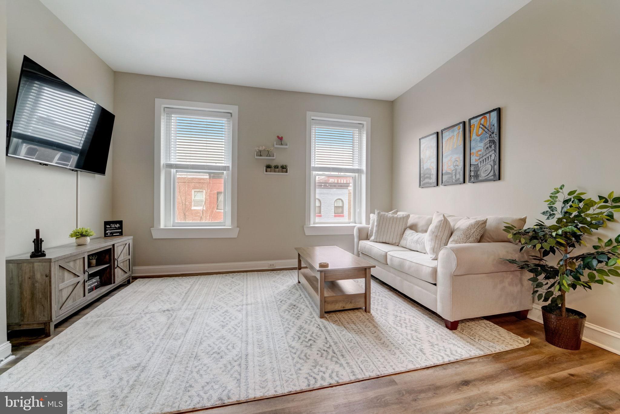 1628 North Calvert Street Baltimore, MD 21202 - Photo 37 of 50 a living room with furniture and a flat screen tv