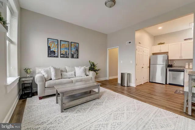 a kitchen with cabinets wooden floor and stainless steel appliances