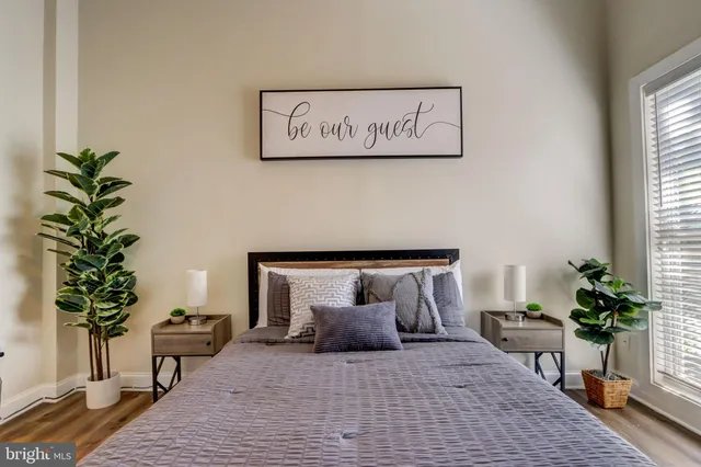 a bedroom with a bed and a potted plant