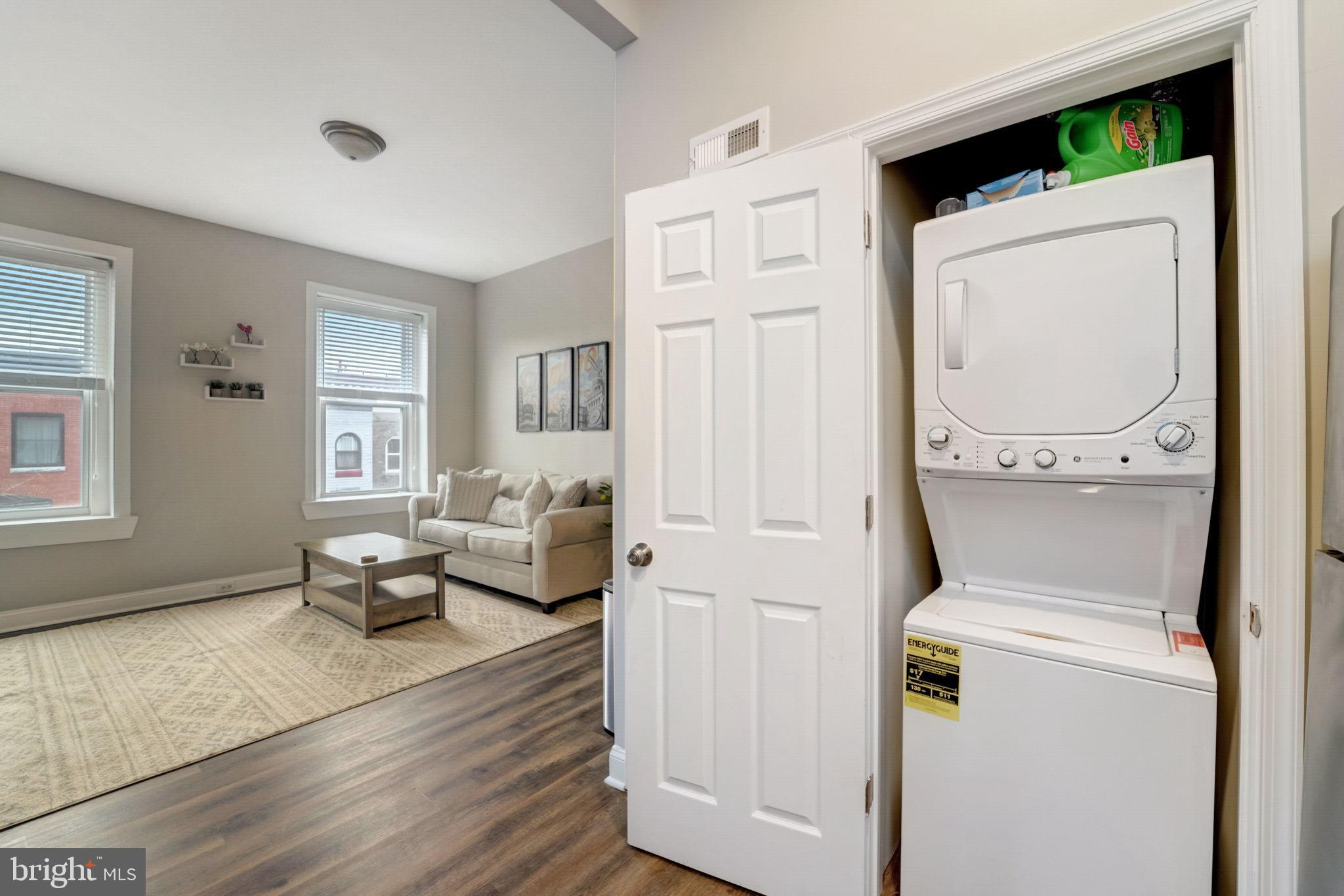 1628 North Calvert Street Baltimore, MD 21202 - Photo 43 of 50 a living room with furniture and a wooden floor