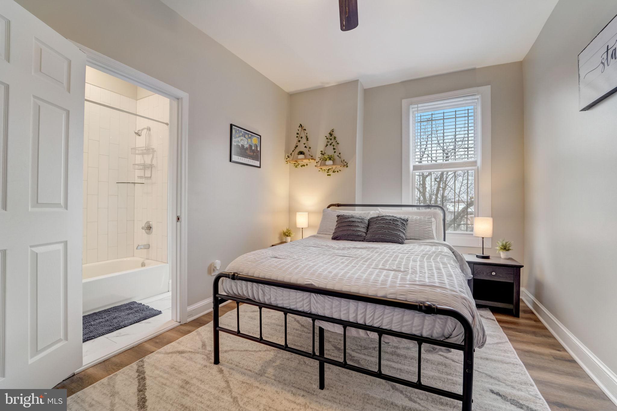 1628 North Calvert Street Baltimore, MD 21202 - Photo 45 of 50 a bedroom with a bed and wooden floor