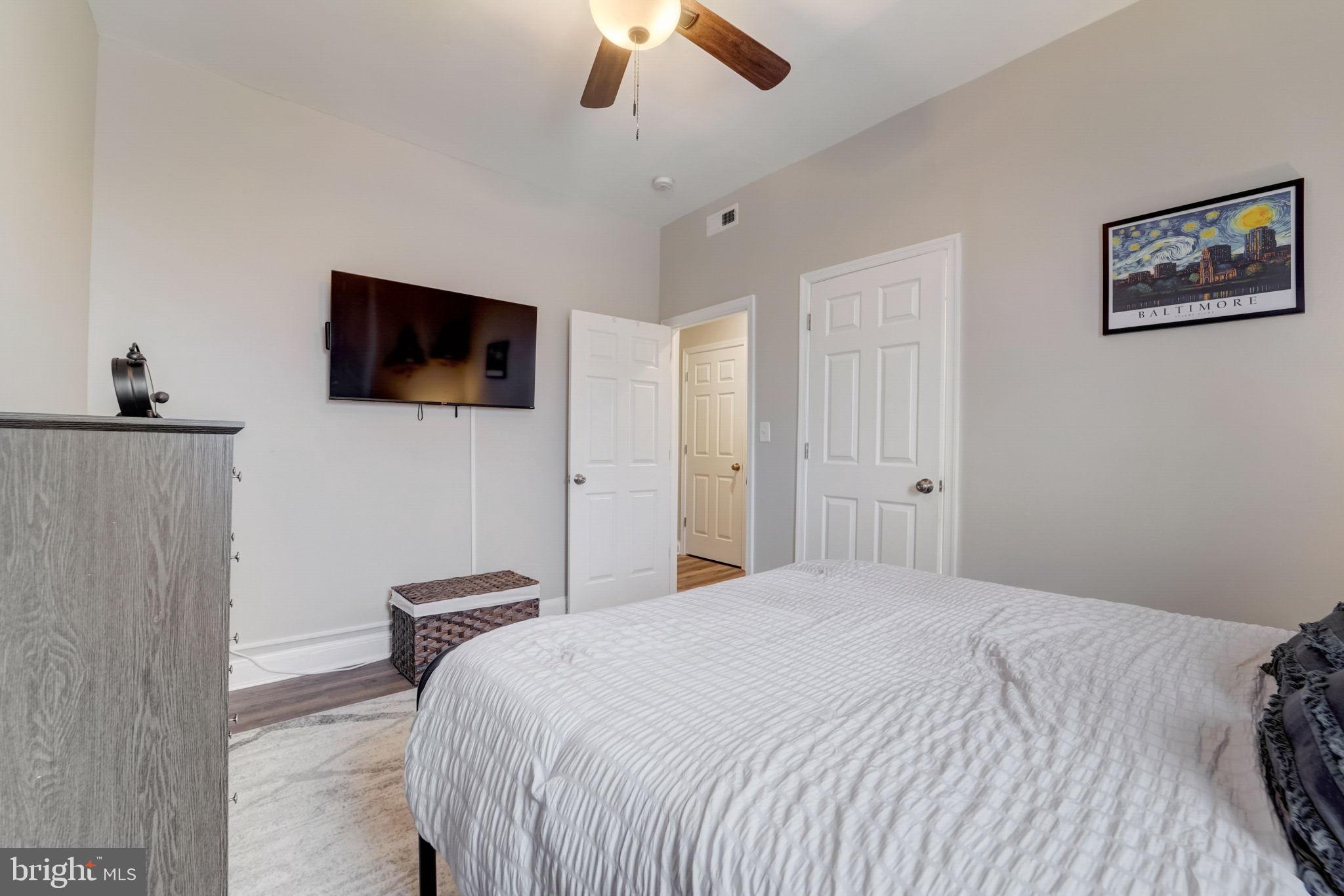 1628 North Calvert Street Baltimore, MD 21202 - Photo 46 of 50 a bedroom with a bed and a flat screen tv