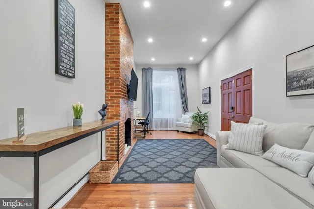 a living room with furniture and wooden floor