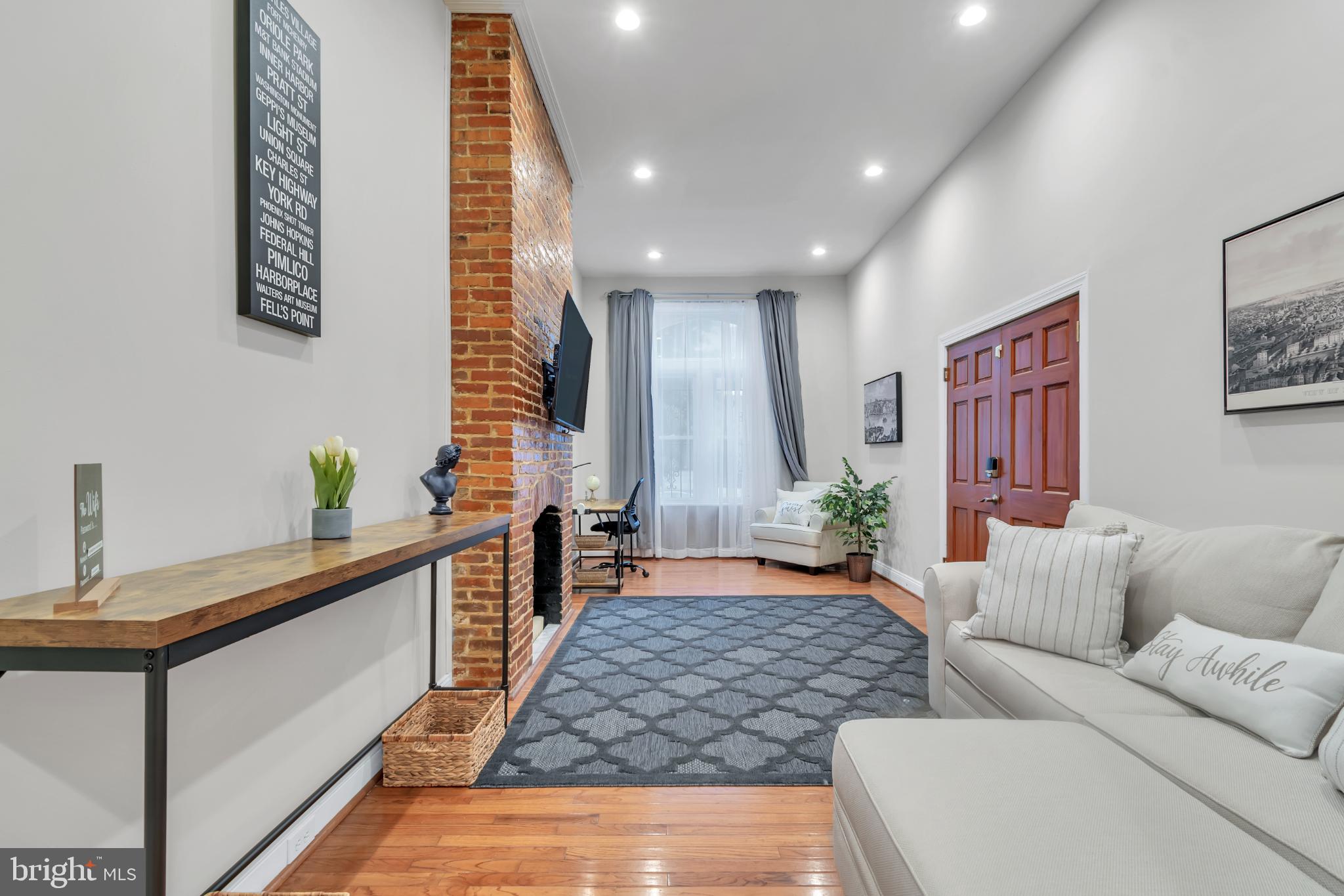 1628 North Calvert Street Baltimore, MD 21202 - Photo 7 of 50 a living room with furniture and wooden floor