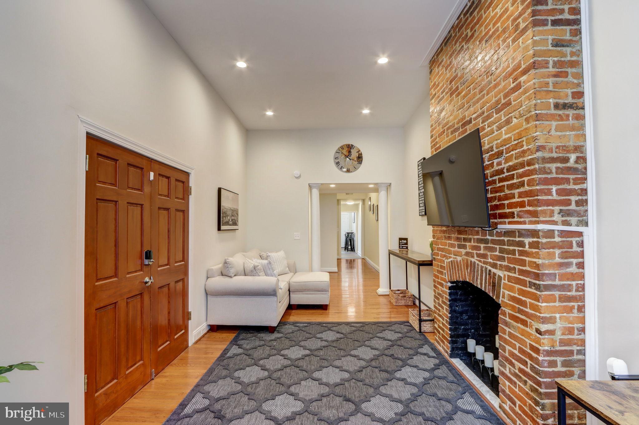 1628 North Calvert Street Baltimore, MD 21202 - Photo 8 of 50 a living room with furniture and a fireplace