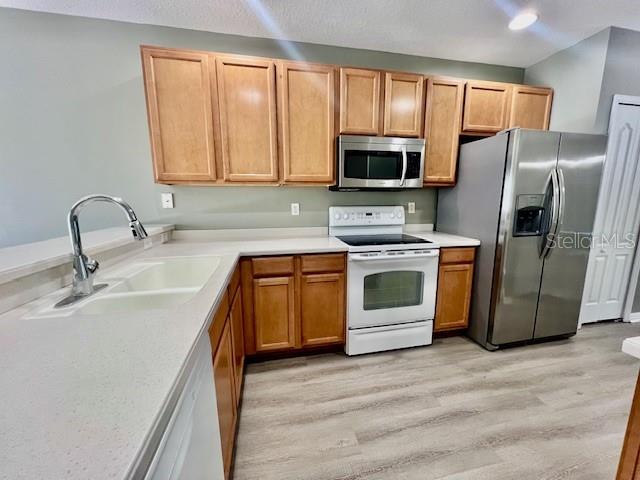 15655 Stable Run Drive Spring Hill, FL 34610 - Photo 13 of 48 a kitchen with stainless steel appliances a stove sink and microwave